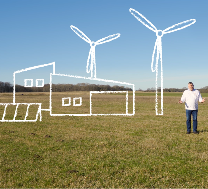 Medlem af Verdensmålsudvalget Karl Erik Slynge står på en mark, som skal blive til Recycling City.